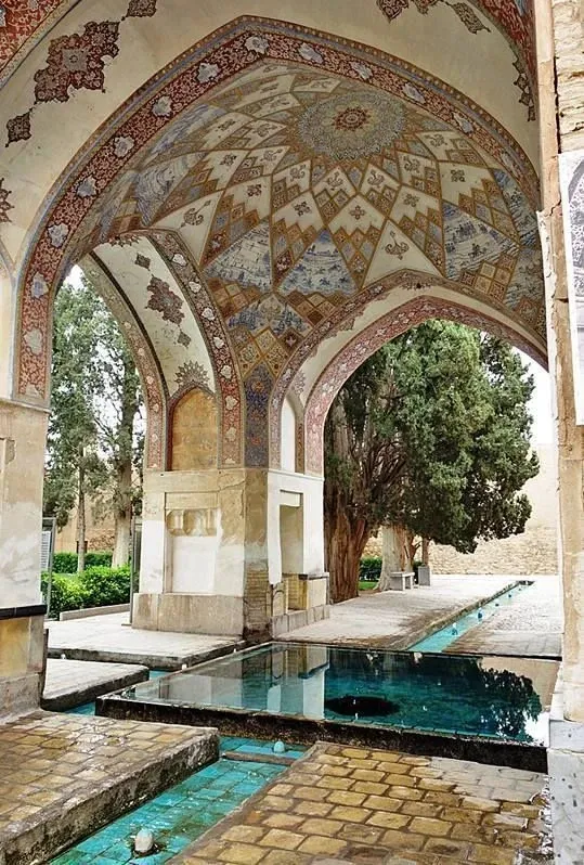 Fin Garden, Kashan: a painted pavilion over turquoise water channels lined with cypress trees